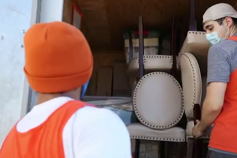 Carrying dining chairs to the truck